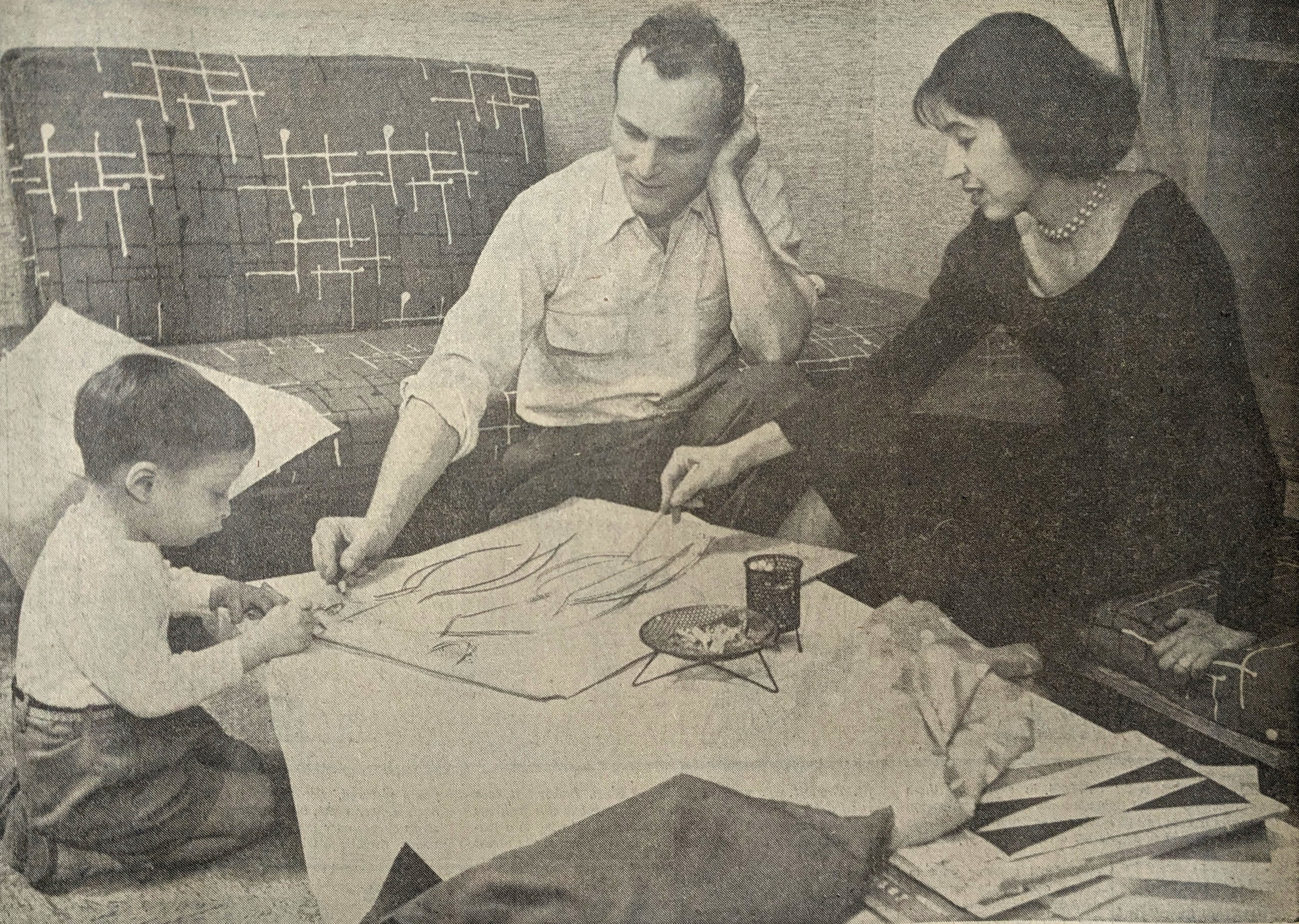 Black and white image of a child, man and woman