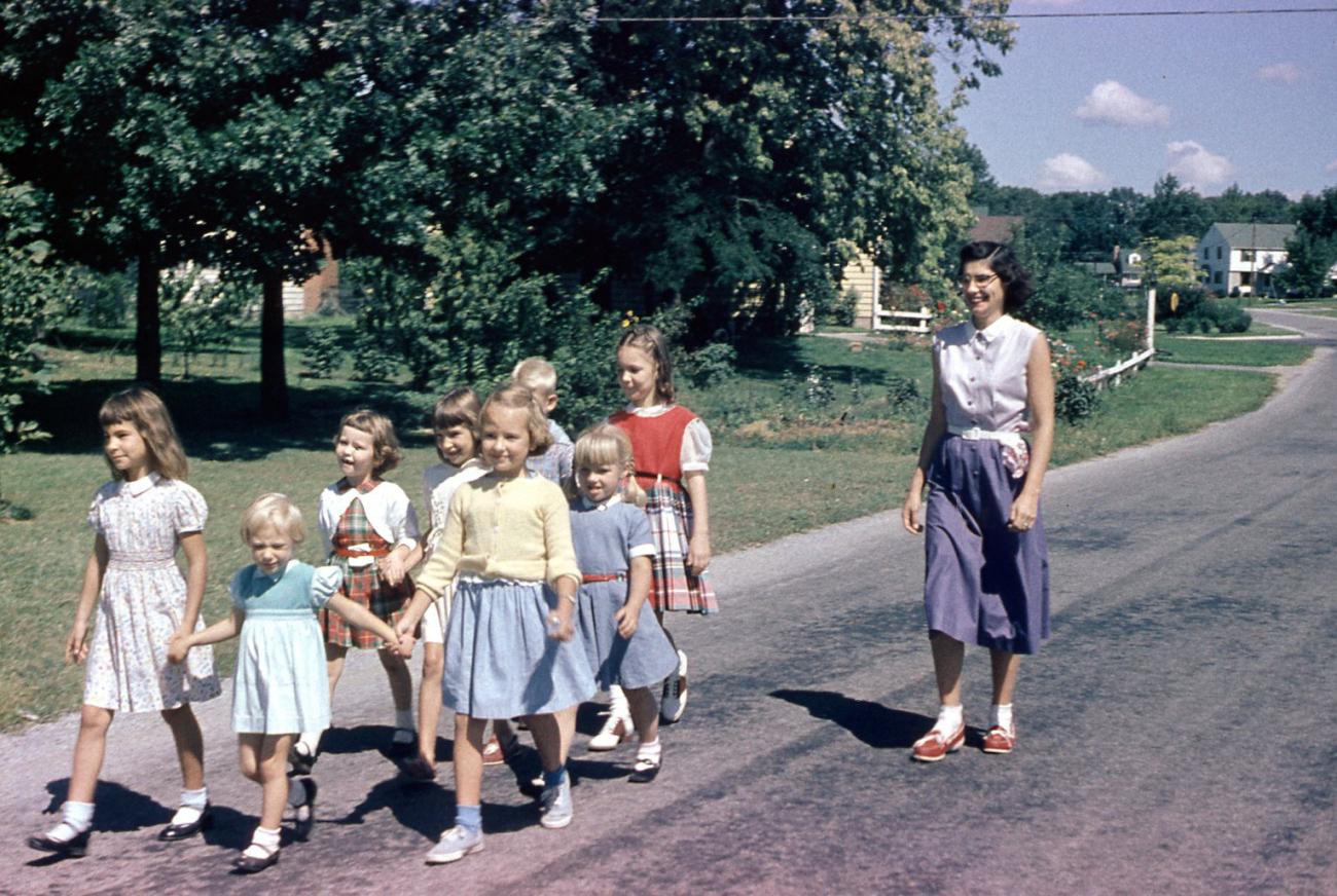 An Adult and Group of Children Walking on Andover Street, 1950s