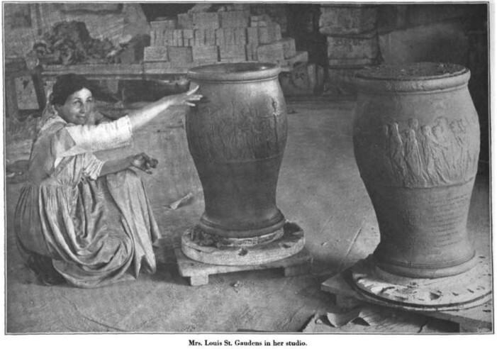 Black and white photo of a woman kneeling on the floor next to two large urns