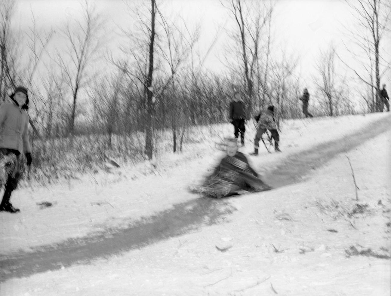 Child Sledding Down "Devil's Hill" Sled Run