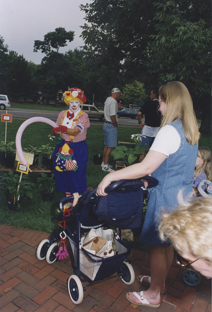 Clown Making Balloon Animal for Child in Stroller at Worthington Farmers Market
