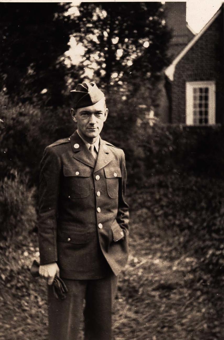John Long in Uniform Standing Outside of a House