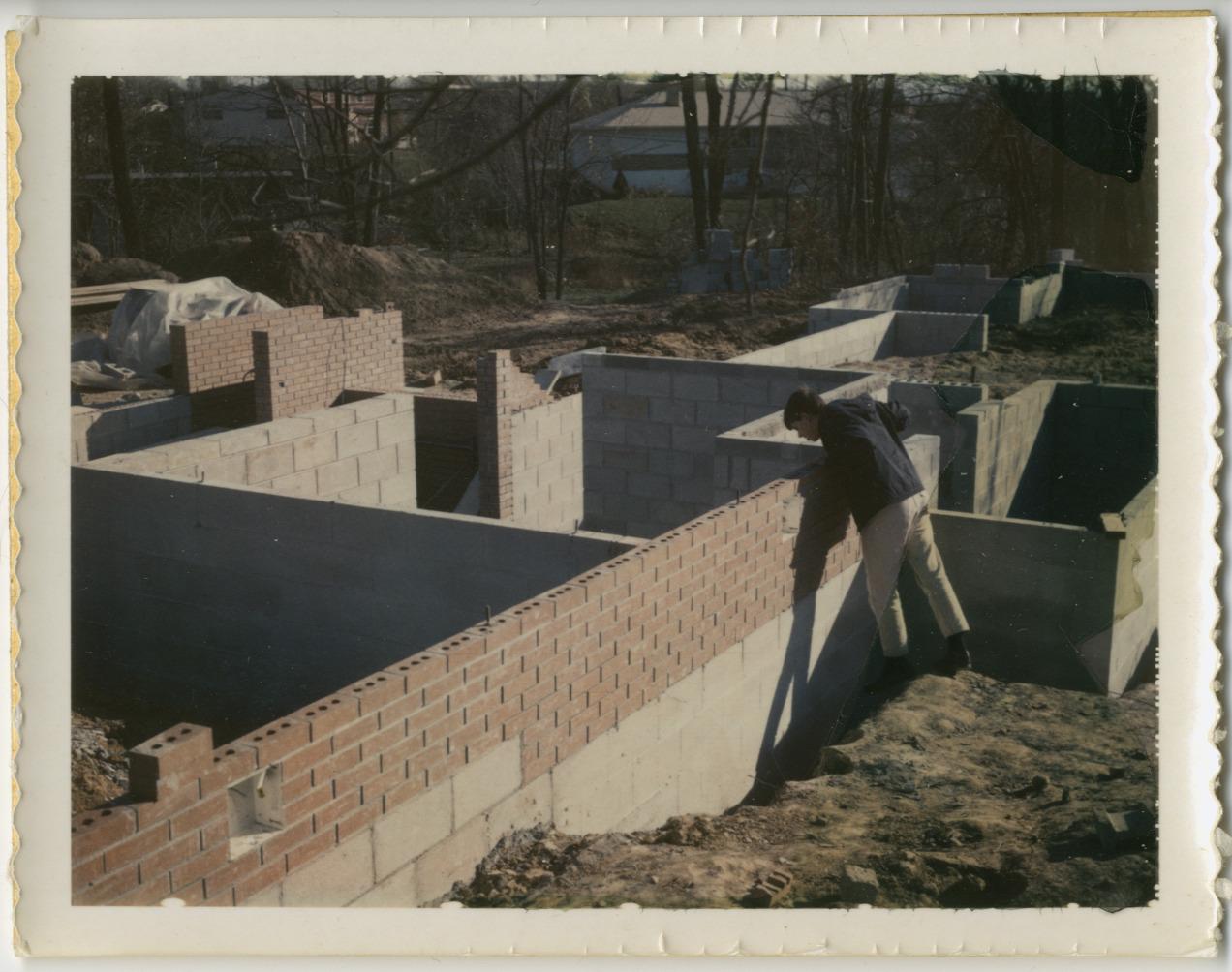 Person Peering into Foundation During Construction of 500 Evergreen Circle