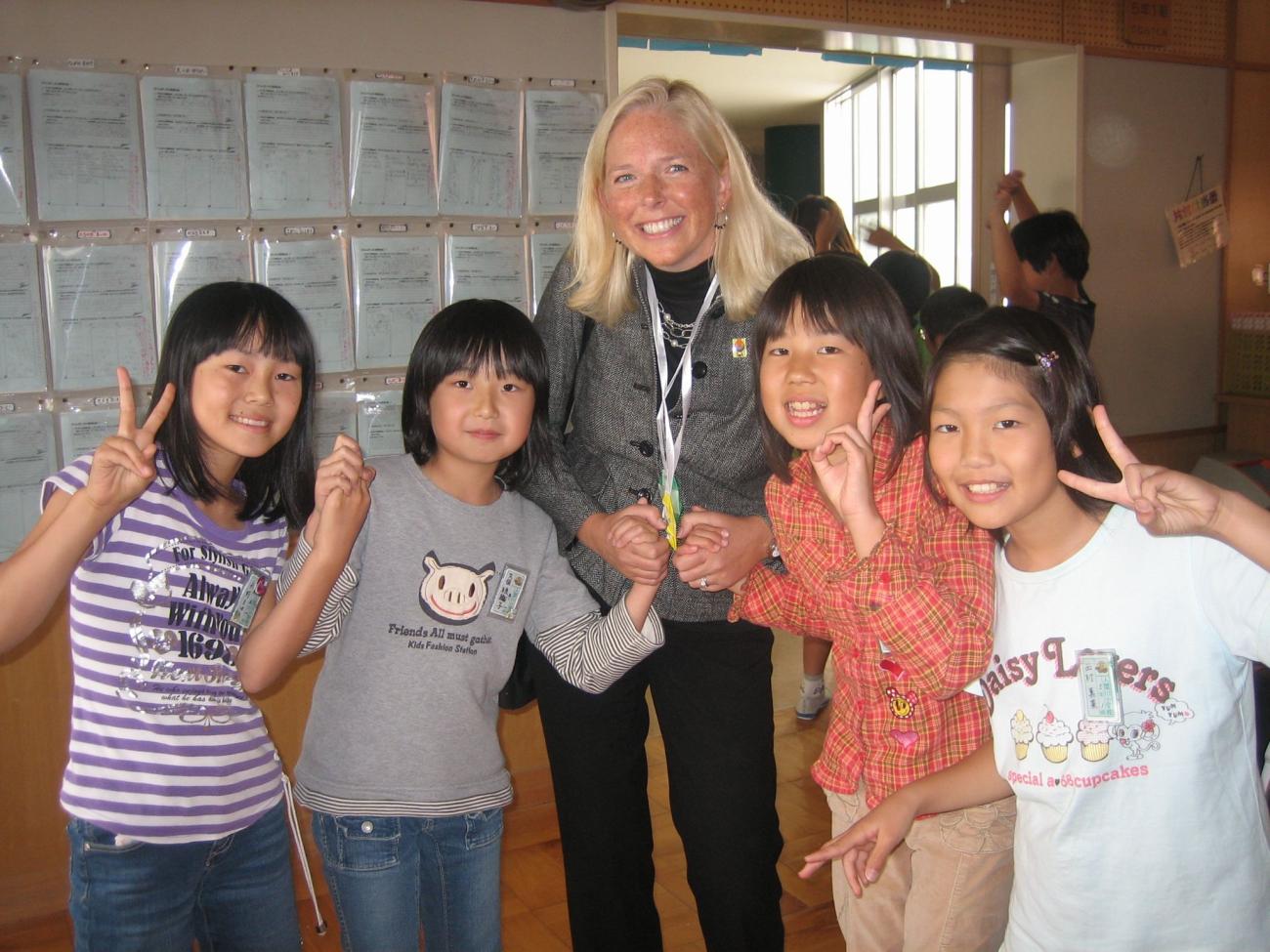 Photograph of Anne Brown with elementary school students in Sayama, Japan