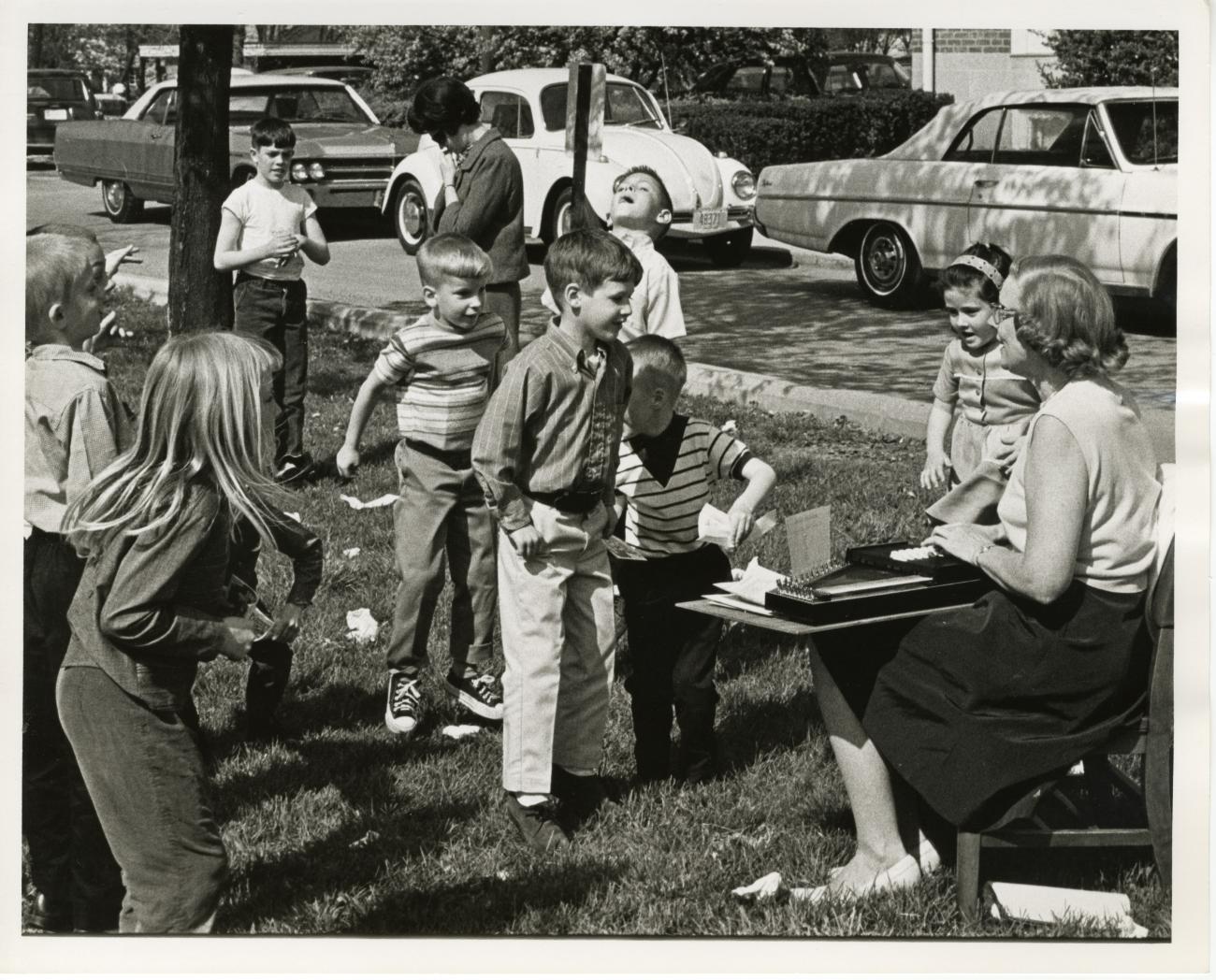Photograph of Children and Adult with Autoharp Outside at the Worthington Public Library's National Library Week Celebration, 1968