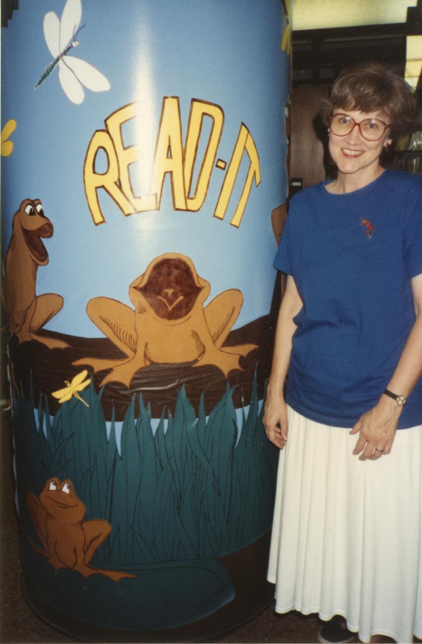 Photograph of Jo Osborne with "Read It" Pillar in Children's Area at the Old Worthington Library
