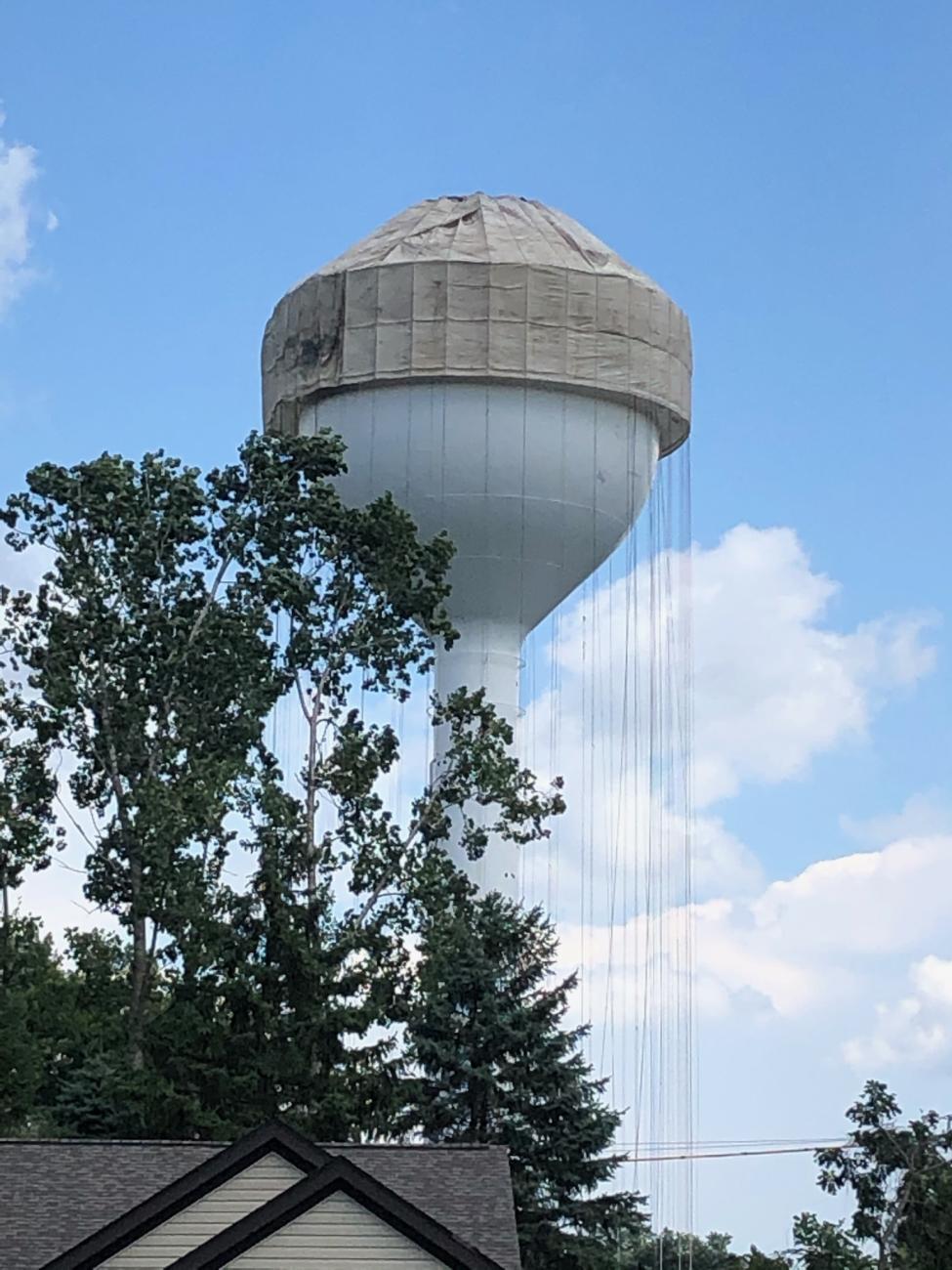 Photograph of Tarp Being Lowered Over Worthington Hills Water Tower Before Repainting, 2020