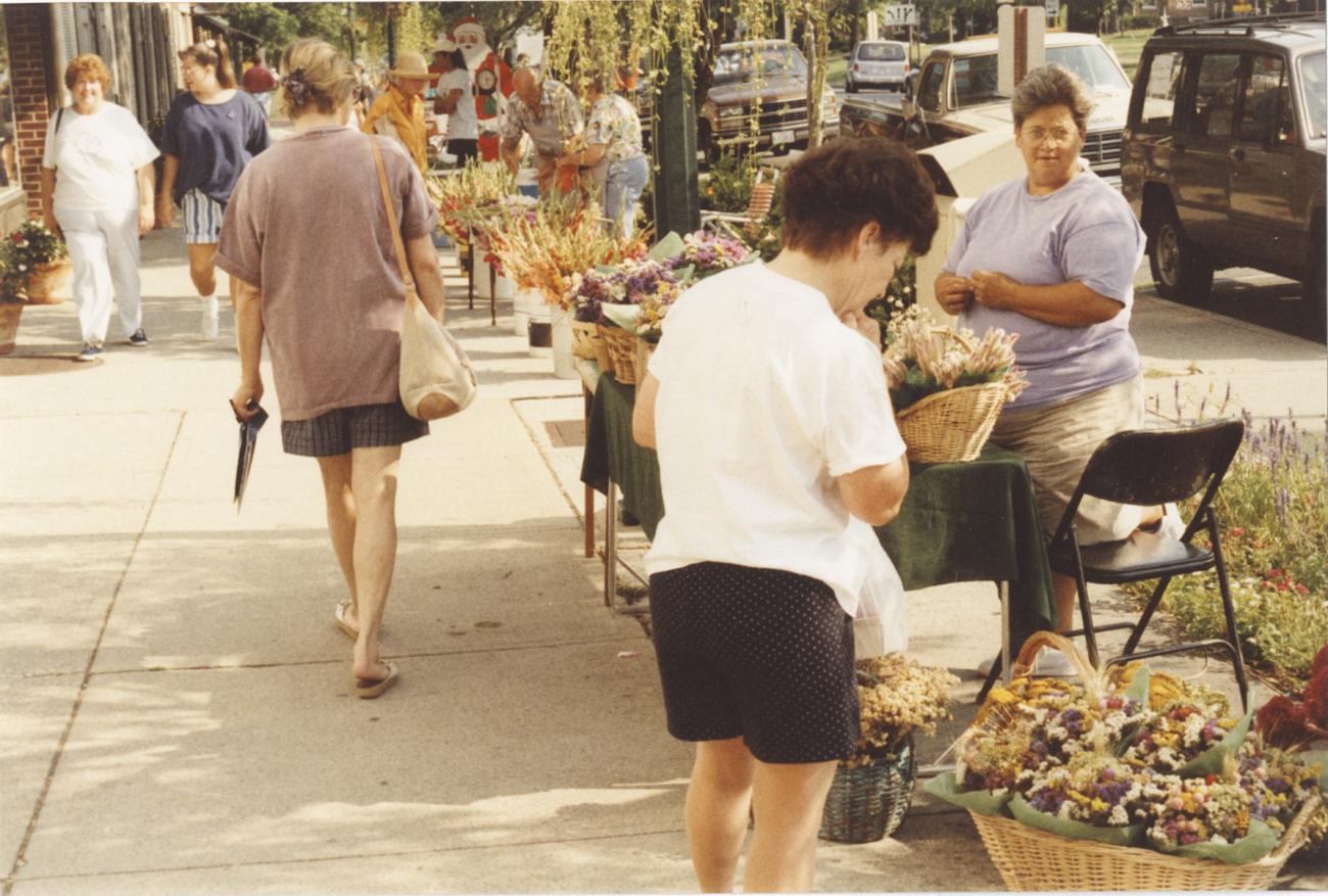 Shopper Viewing Dried Flower Arrangements at the Worthington Farmer's Market