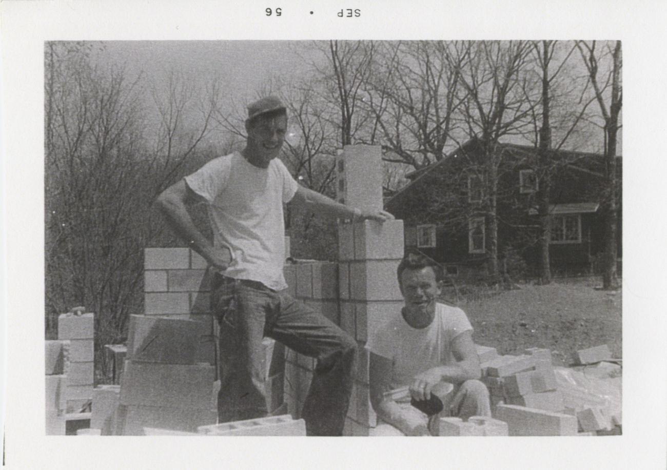 Two People Standing with Foundation Blocks for 290 E. South Street