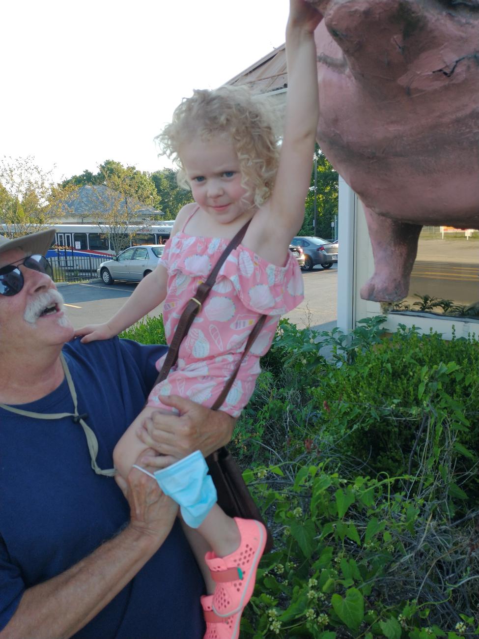 William (bc) (Bill) Collins with Granddaughter at the Iron Grill Pig Statue