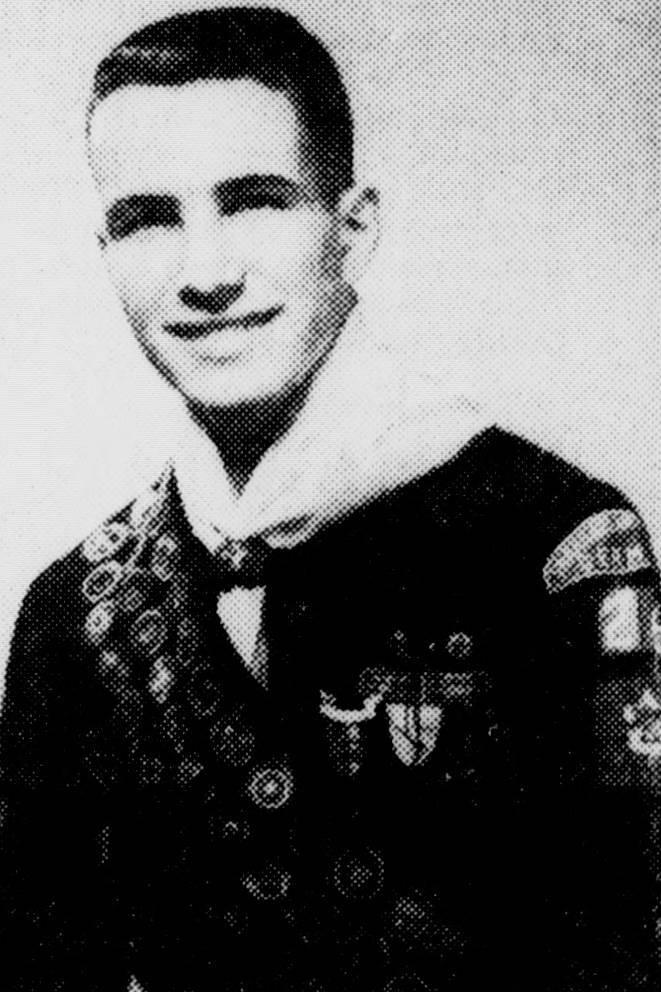 Black and white portrait of a smiling young man in military uniform