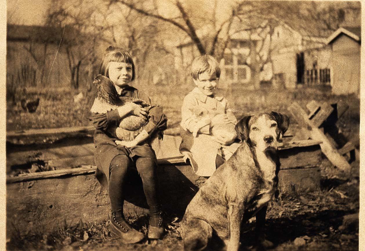 Ellen Gloyd and an Unidentified Child Sitting Outside with Animals