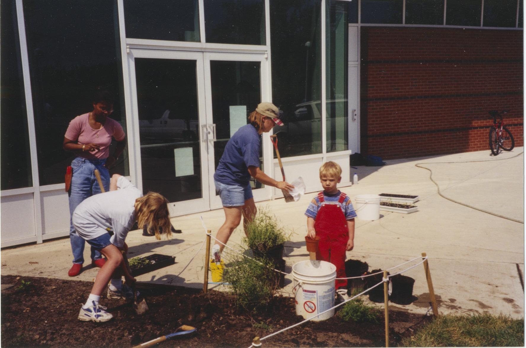 Photograph of Children and Adults Planting Storybook Garden at Northwest Library