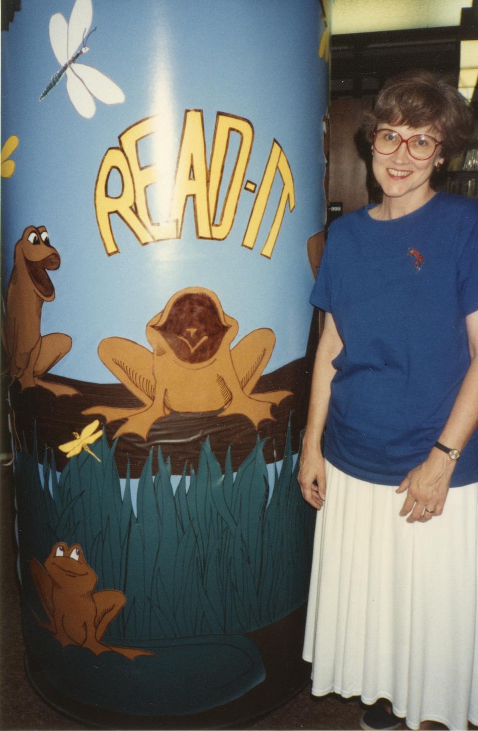 Photograph of Jo Osborne with "Read It" Pillar in Children's Area at the Old Worthington Library
