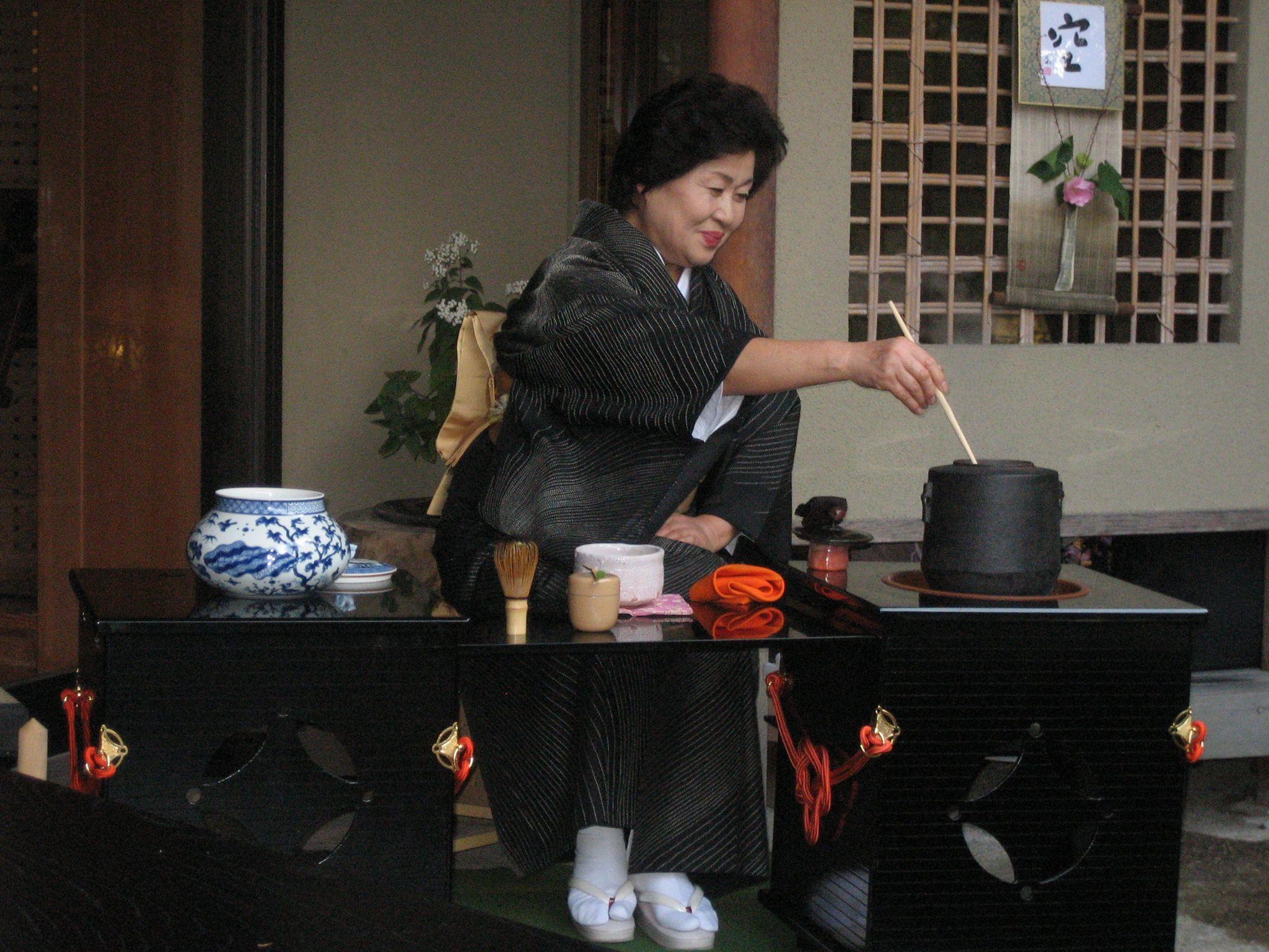 Photograph of a woman in Sayama, Japan preparing green tea