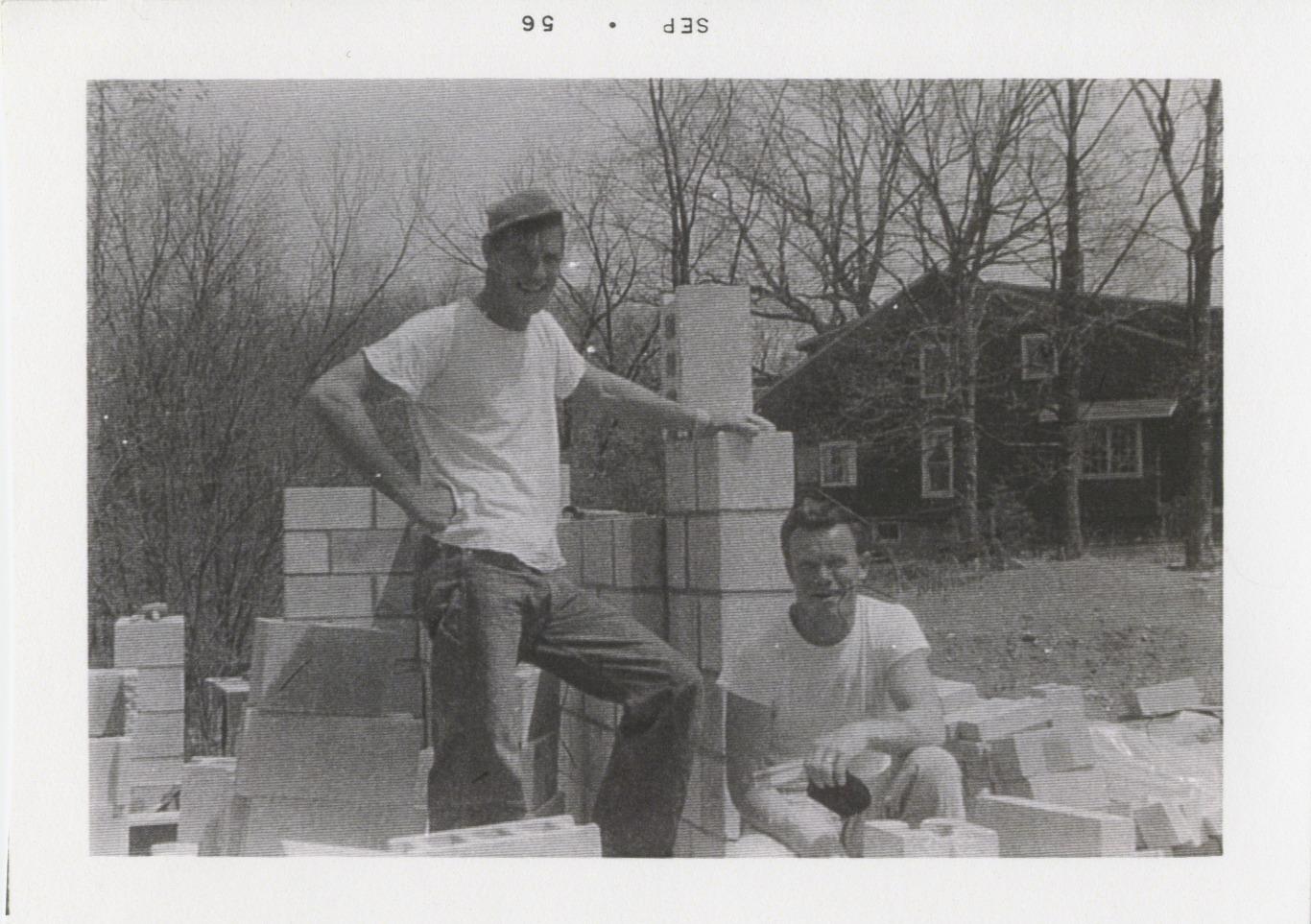 Two People Standing with Foundation Blocks for 290 E. South Street