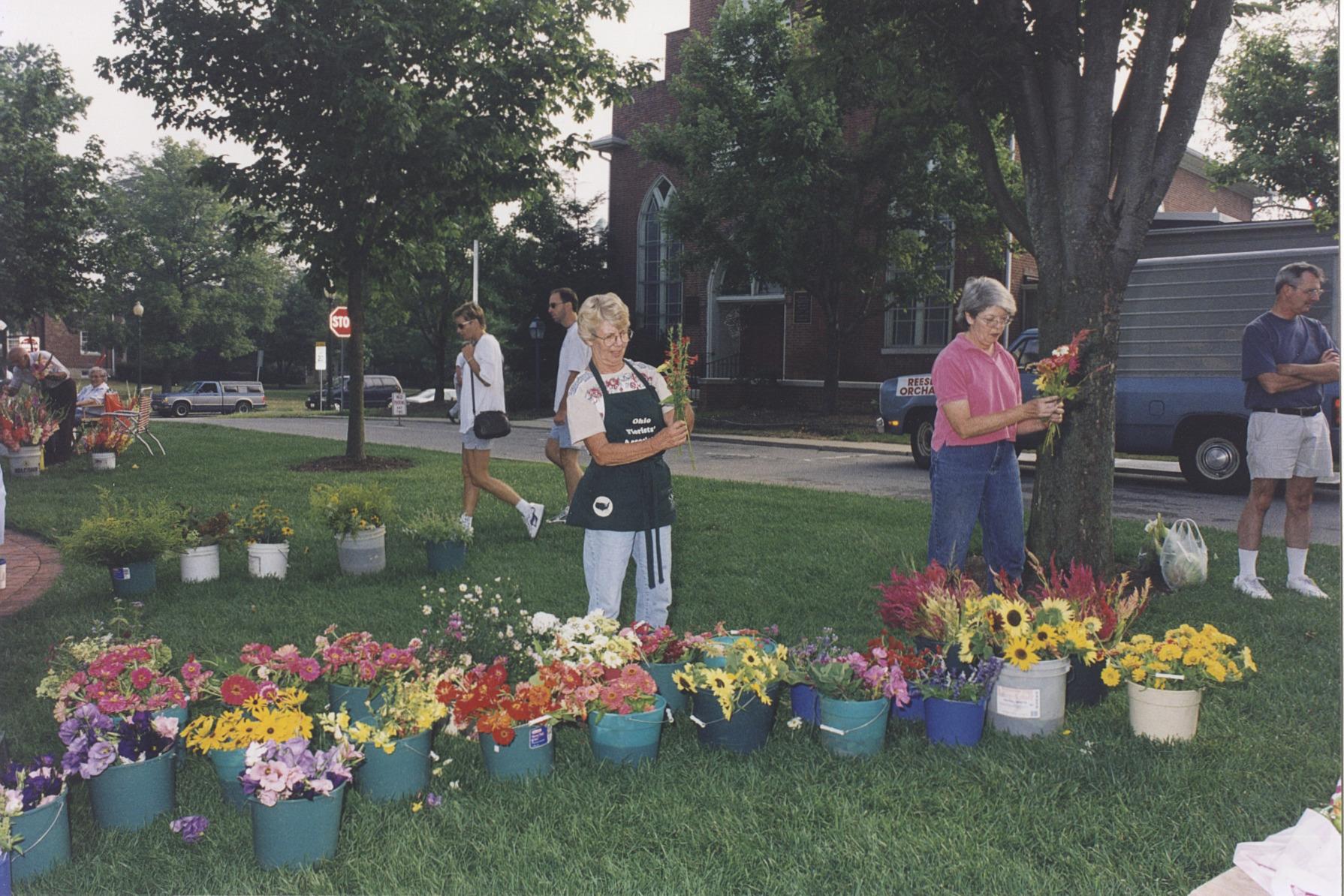 Vendors with Buckets of Flowers at the Worthington Farmer's Market