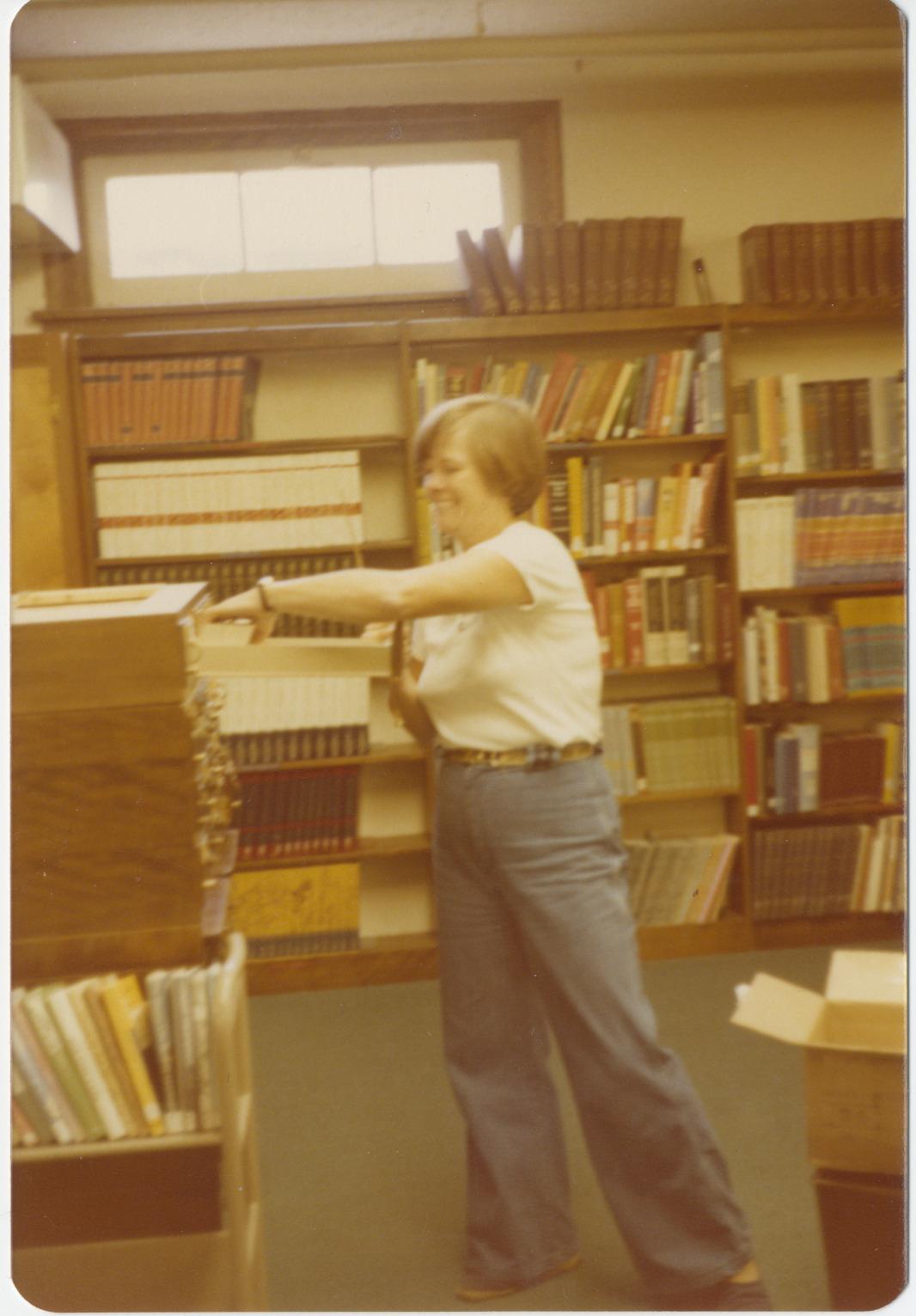 Worthington Public Library Director Bernice Daniels Throwing Away Cards from Card Catalog