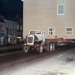 Color photo of the Old Rectory being moved on a flatbed truck
