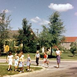 An Adult and Group of Children at the Intersection of Kenbrook Drive and Andover Street, 1950s