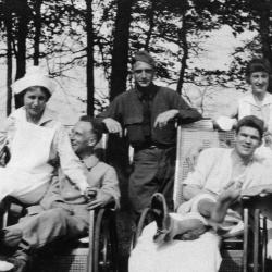 Black and white photograph of two World War I nurses and four soldiers seated and standing