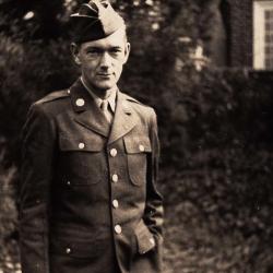 John Long in Uniform Standing Outside of a House