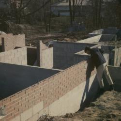 Person Peering into Foundation During Construction of 500 Evergreen Circle