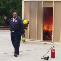 Photograph of Chief William (Bill) Fields, Jr. Narrating Fire Safety Demonstration