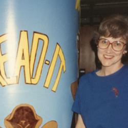 Photograph of Jo Osborne with "Read It" Pillar in Children's Area at the Old Worthington Library