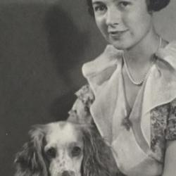 Black-and-white photo of young woman and dog