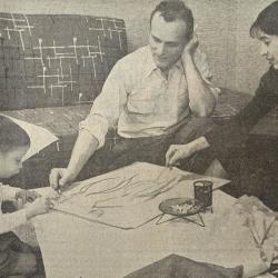 Black and white image of a child, man and woman
