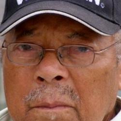 Color photograph of Herbert McGee in World War II Veteran baseball cap
