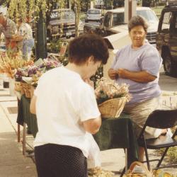 Shopper Viewing Dried Flower Arrangements at the Worthington Farmer's Market