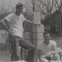 Two People Standing with Foundation Blocks for 290 E. South Street