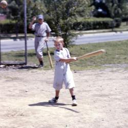 Color photo of child swinging bat