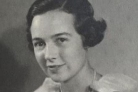 Black and white portrait of woman looking at camera with faint smile