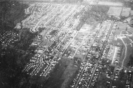 Black and white aerial photograph of streets and homes