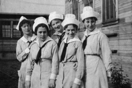 Black and white photograph of five women in World War I Army nurse uniform