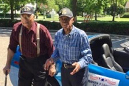 Herbert McGee and Moses Eldridge standing in front of blue convertible