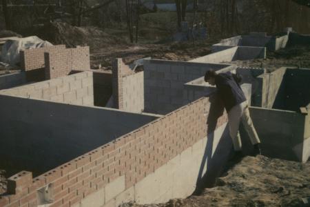 Person Peering into Foundation During Construction of 500 Evergreen Circle