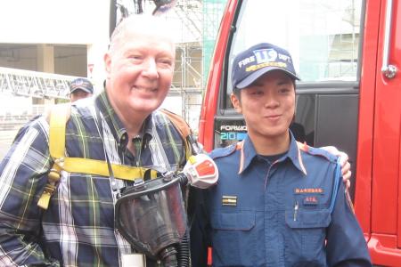 Photograph of Harvey Minton with a firefighter in Sayama, Japan