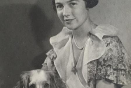 Black-and-white photo of young woman and dog