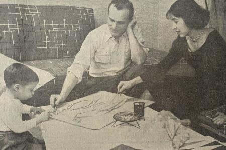 Black and white image of a child, man and woman