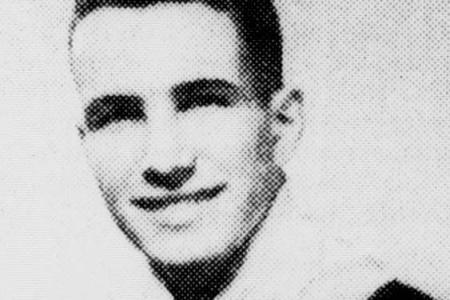 Black and white portrait of a smiling young man in military uniform